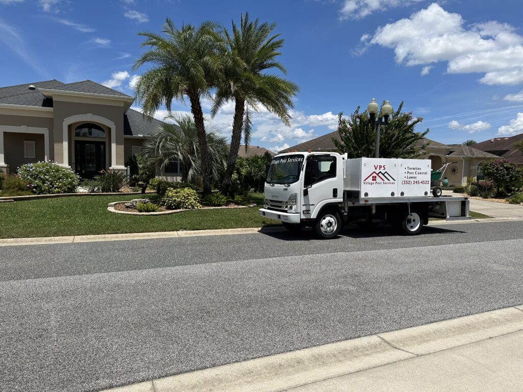 Village Pest Services truck serving a neighborhood in The Villages FL