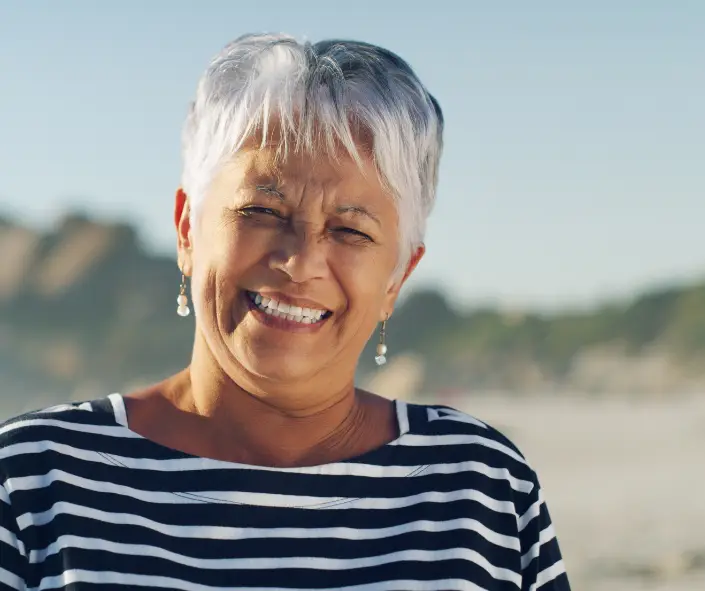 Smiling woman featured with a Village Pest Services customer testimonial