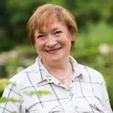 Smiling woman used for a Village Pest Services pest control testimonial